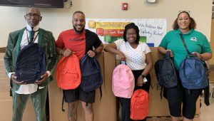 Teachers holding backpacks